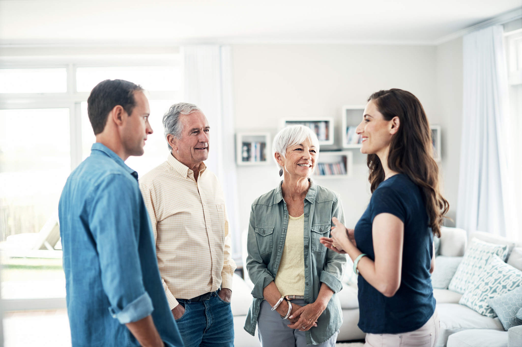 A couple talking with an older couple