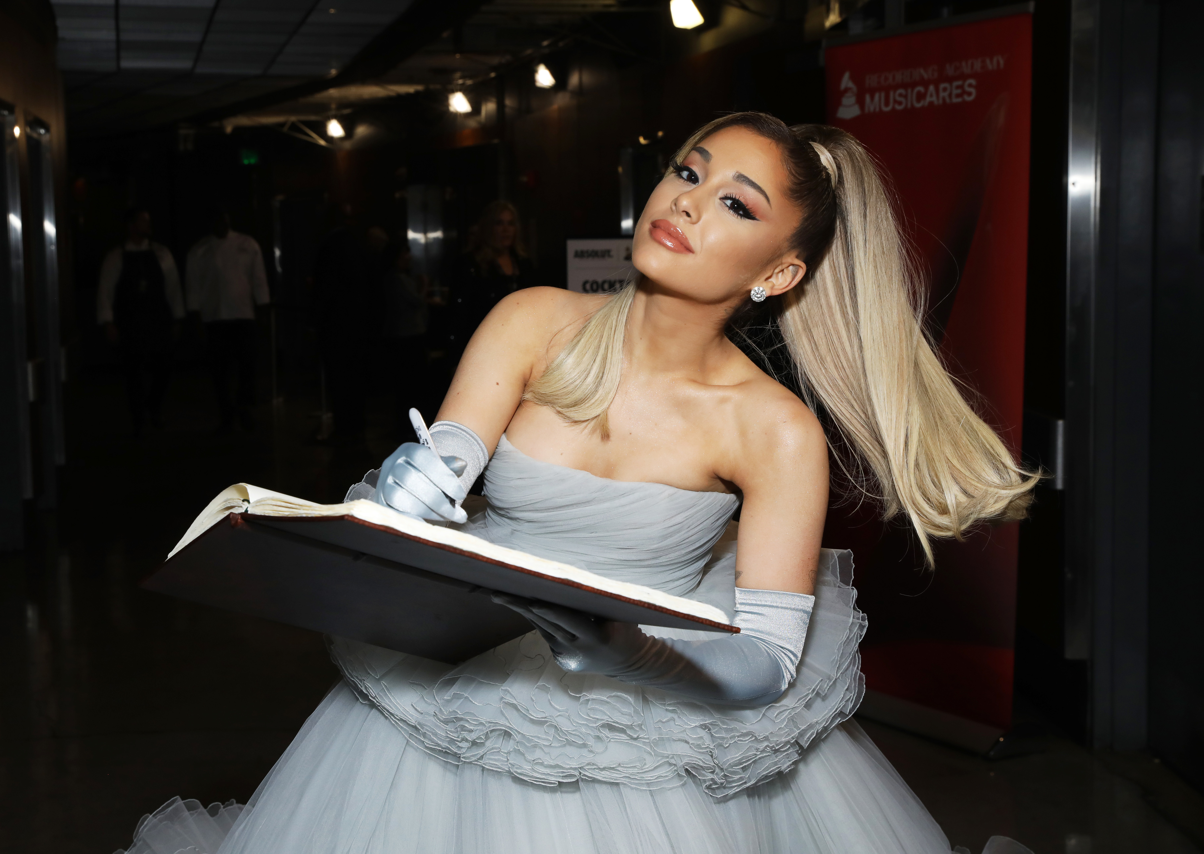 Close-up of Ariana signing a book