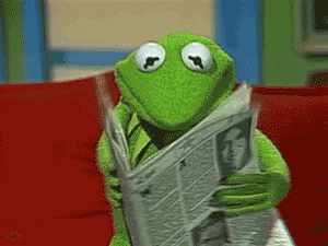 Kermit reads the newspaper.