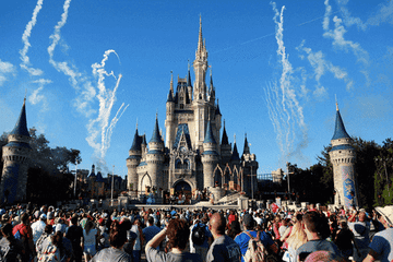Cinderella's castle in Disney World lights up with lights and fireworks.