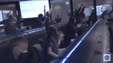 NASA technicians stand up and cheer for Mission Control Mars success.