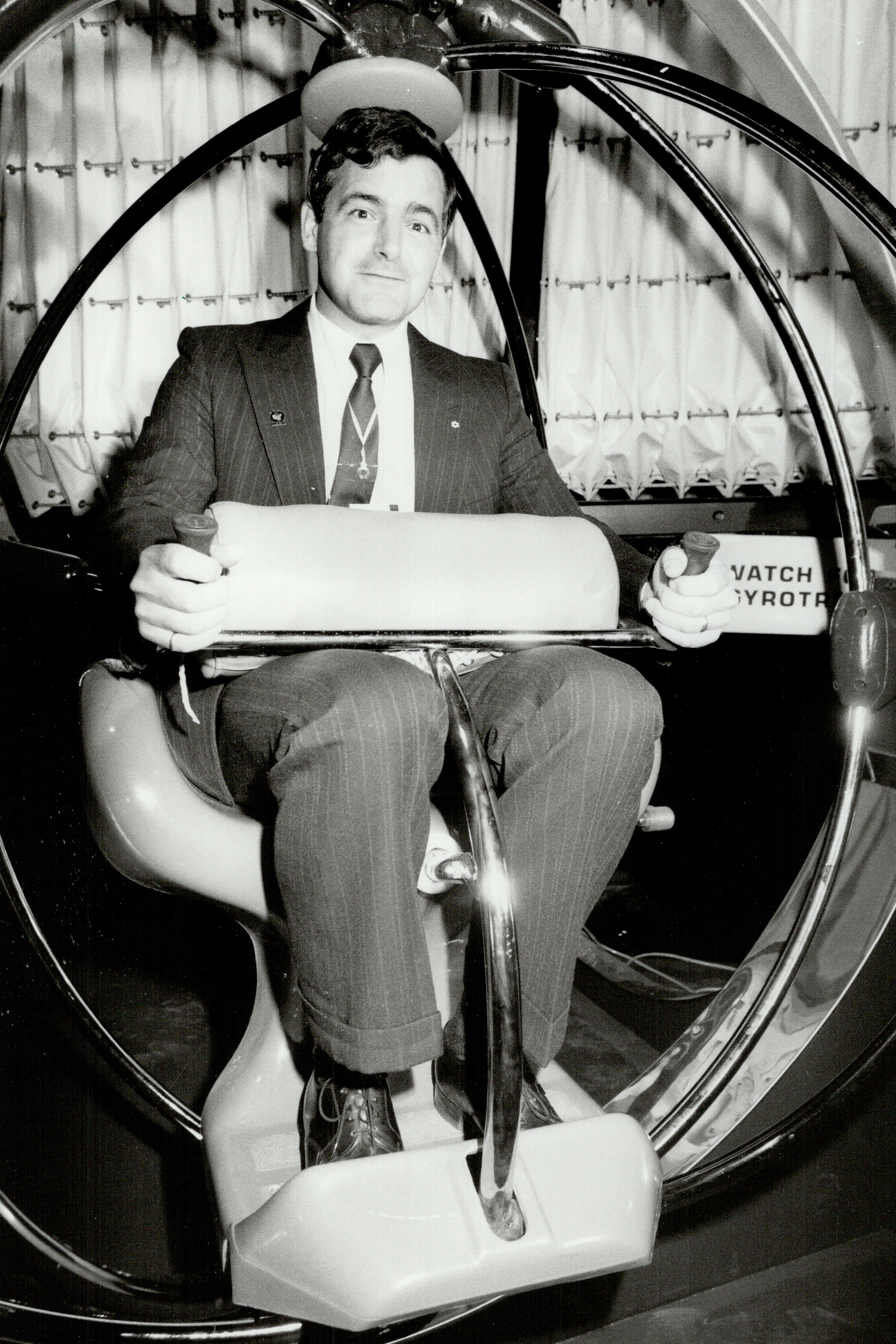 Black and white photograph of young Marc Garneau in a suit.