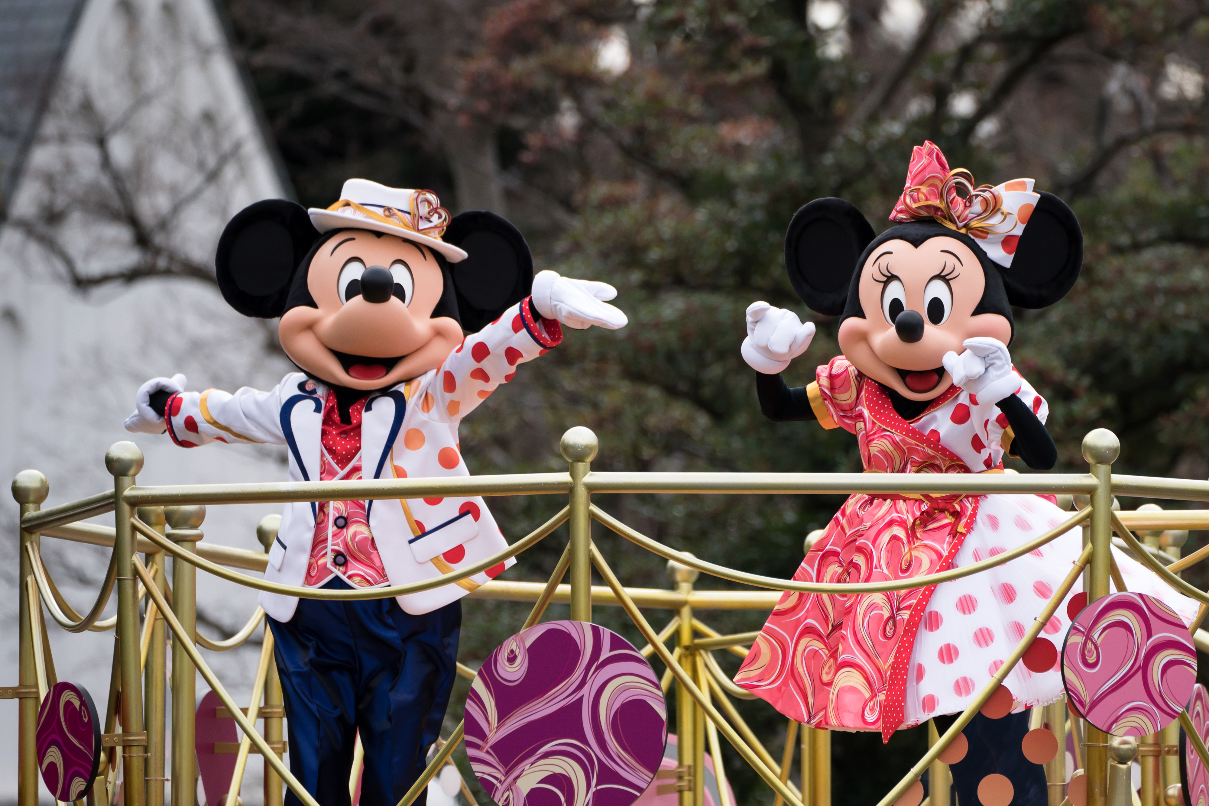 Walt Disney characters Mickey Mouse (L) and Minnie Mouse (R) perform during a press preview for the "Minnie Besties Bash!" parade at Tokyo Disneyland