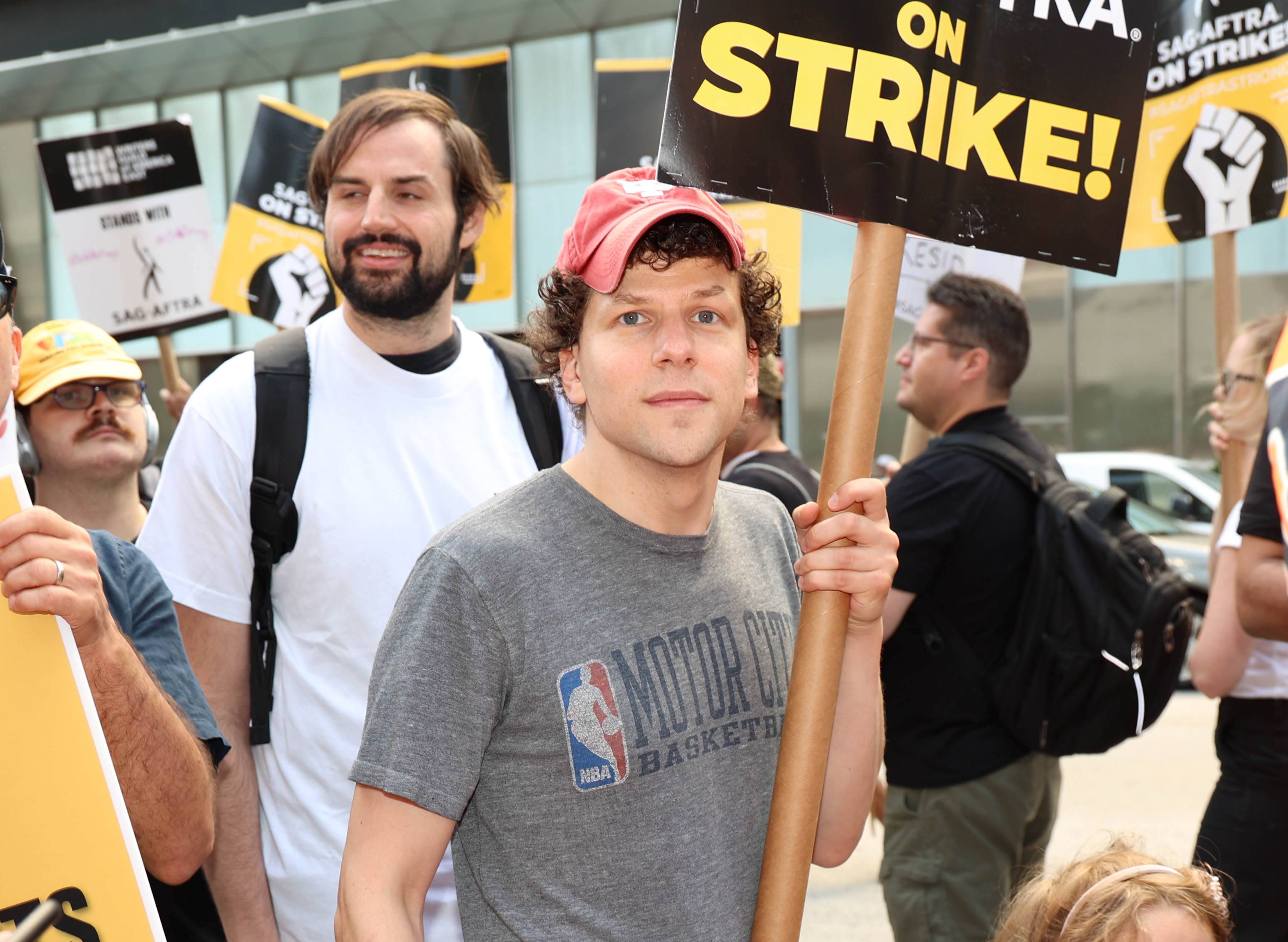 Holding an &quot;On Strike&quot; sign and wearing an NBA T-shirt