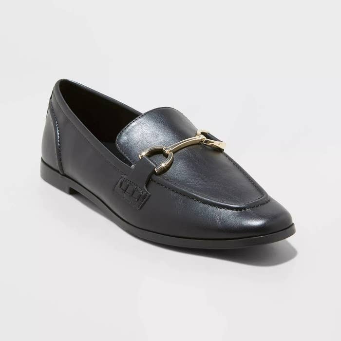 black loafers with gold metal detailing