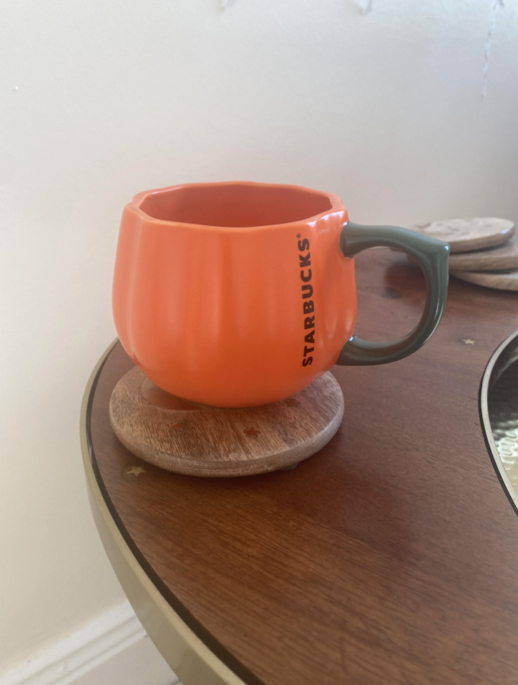 a pumpkin shaped mug on a table