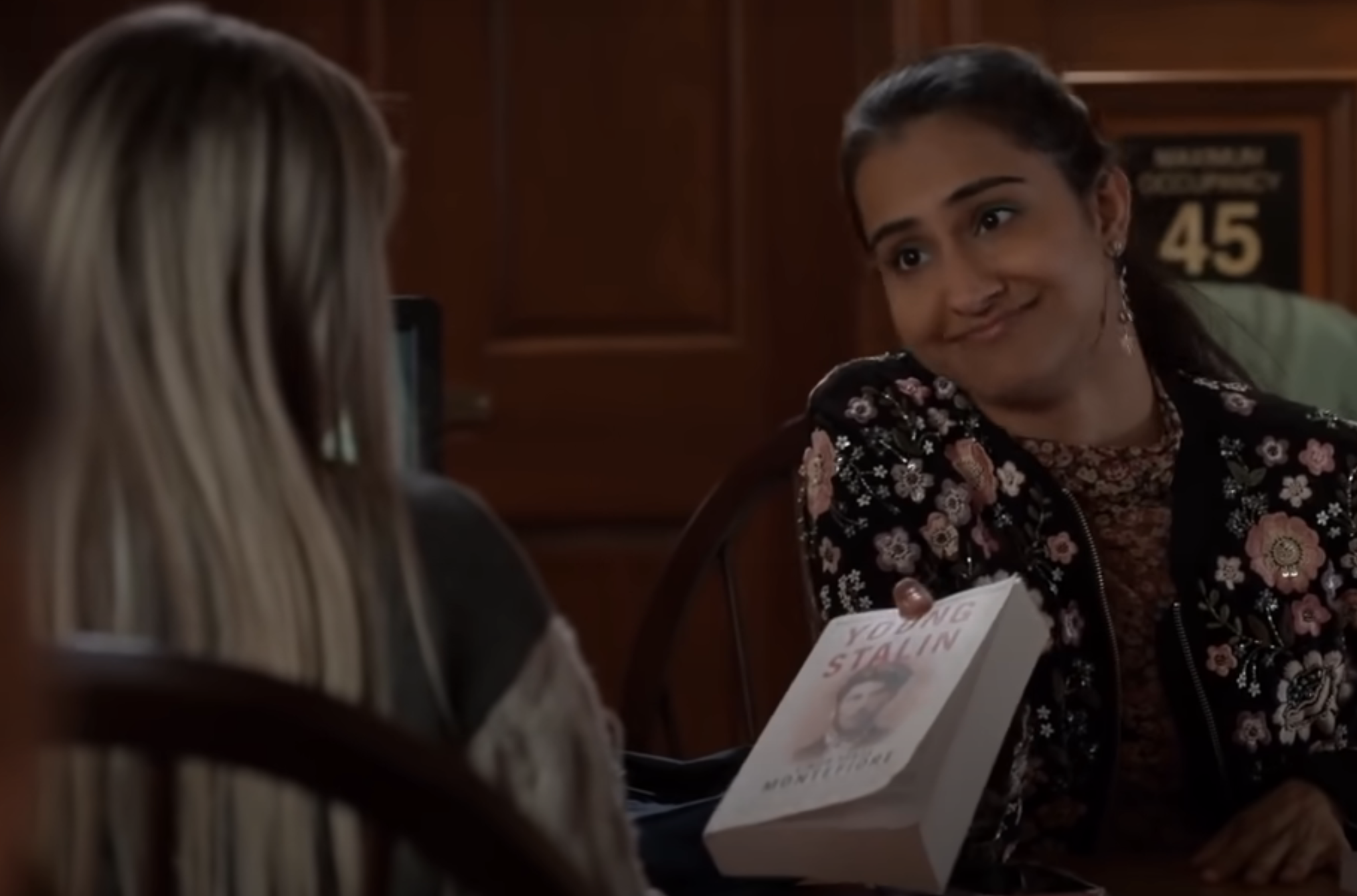 teen handing over a book