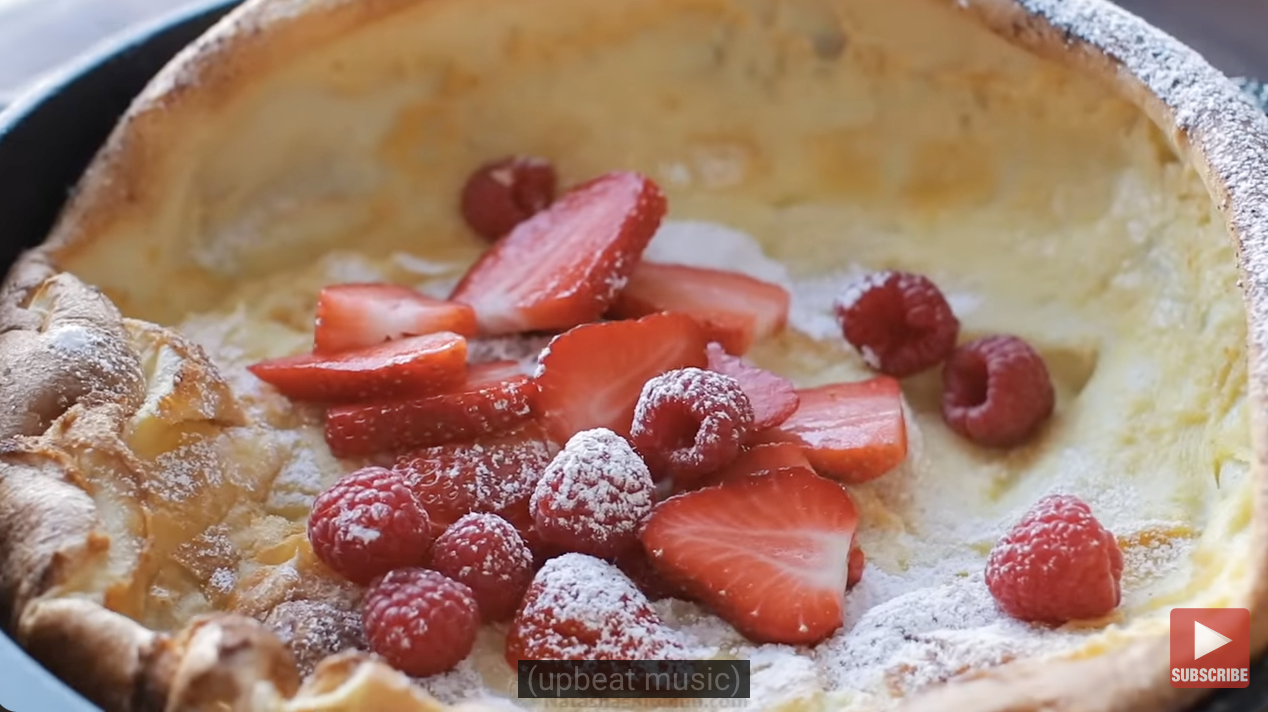 german pancake topped with berries