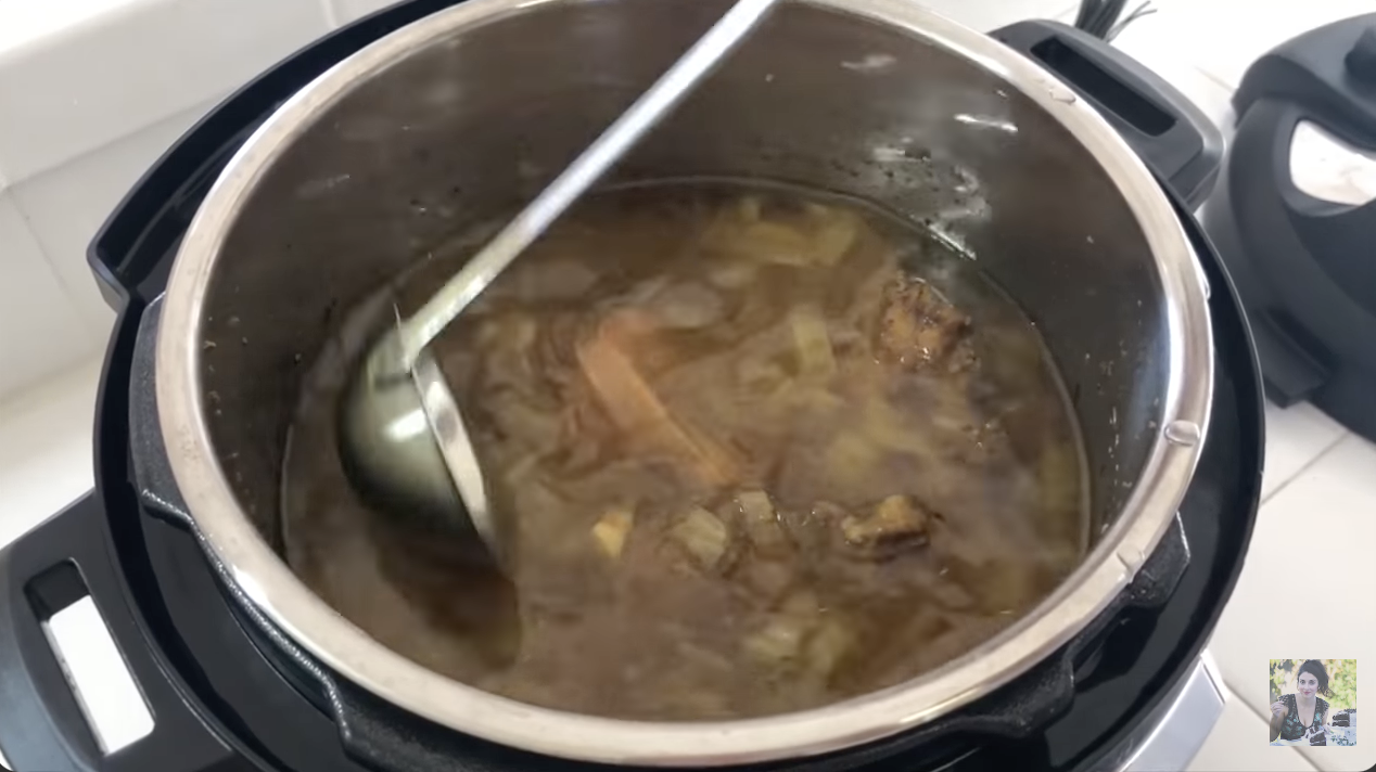 stirring bone broth while it cooks