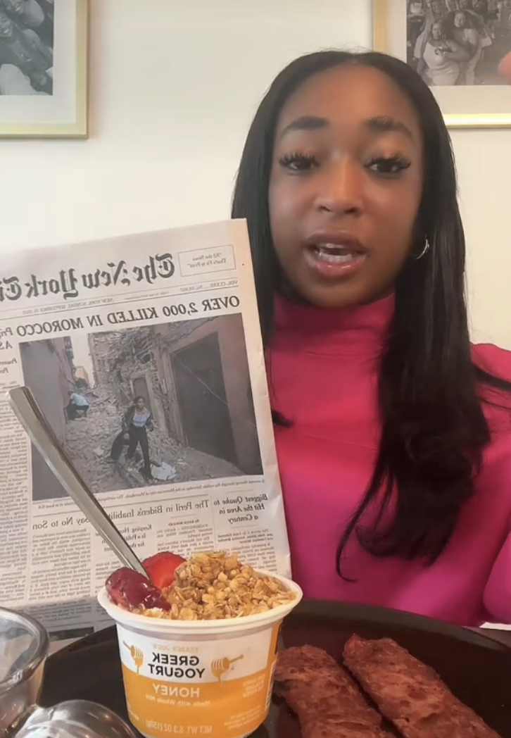 kelsey at her breakfast table with the newspaper