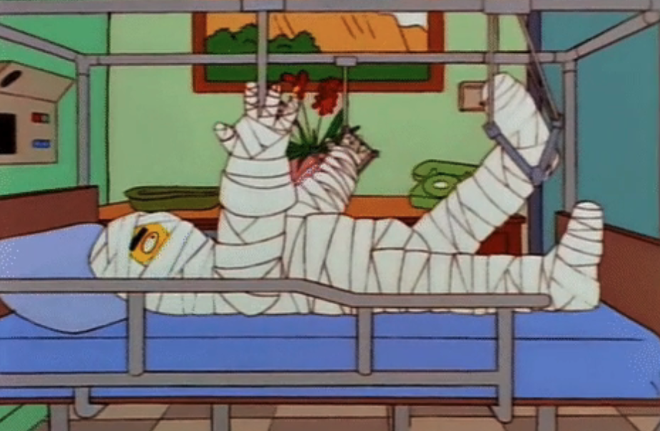 Cartoon of a person laying in a hospital bed completely covered in gauze