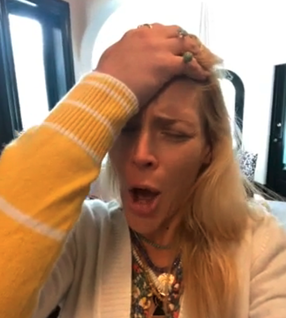 A woman with her hand on her head and a "nooo" expression on her face