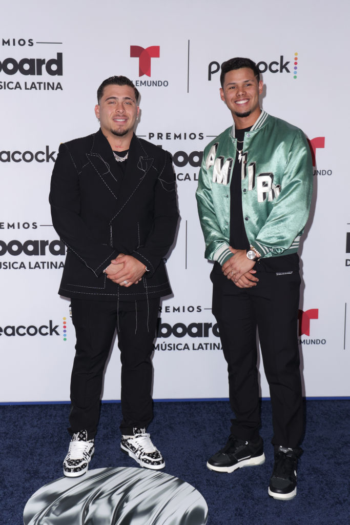 francisco wearing a dark suit with sneakers and ezequiel wearing jeans and members jackets