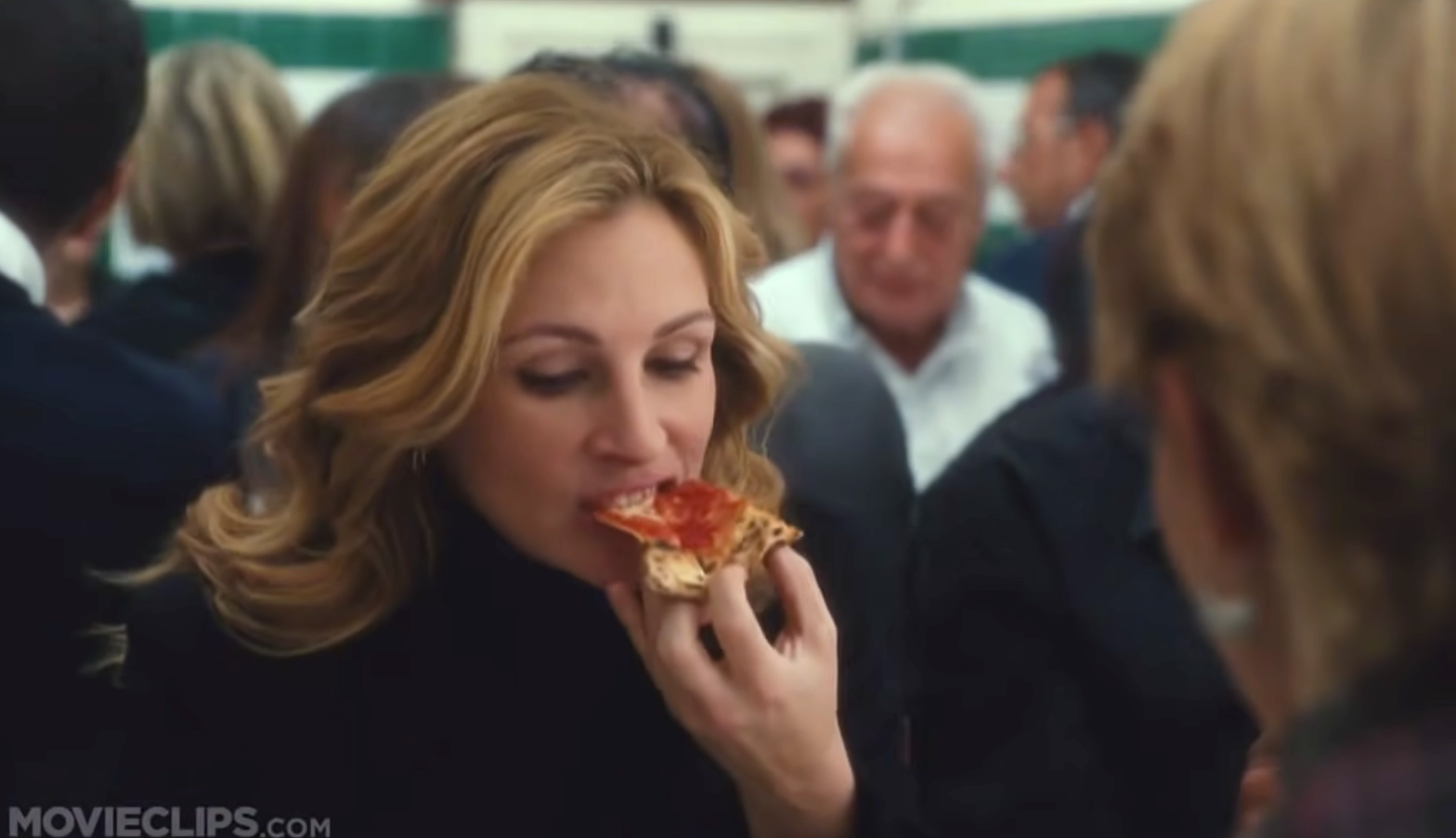 a scene from eat, pray, love of julia roberts eating pizza