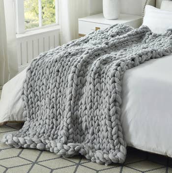 grey knit throw blanket on a bed