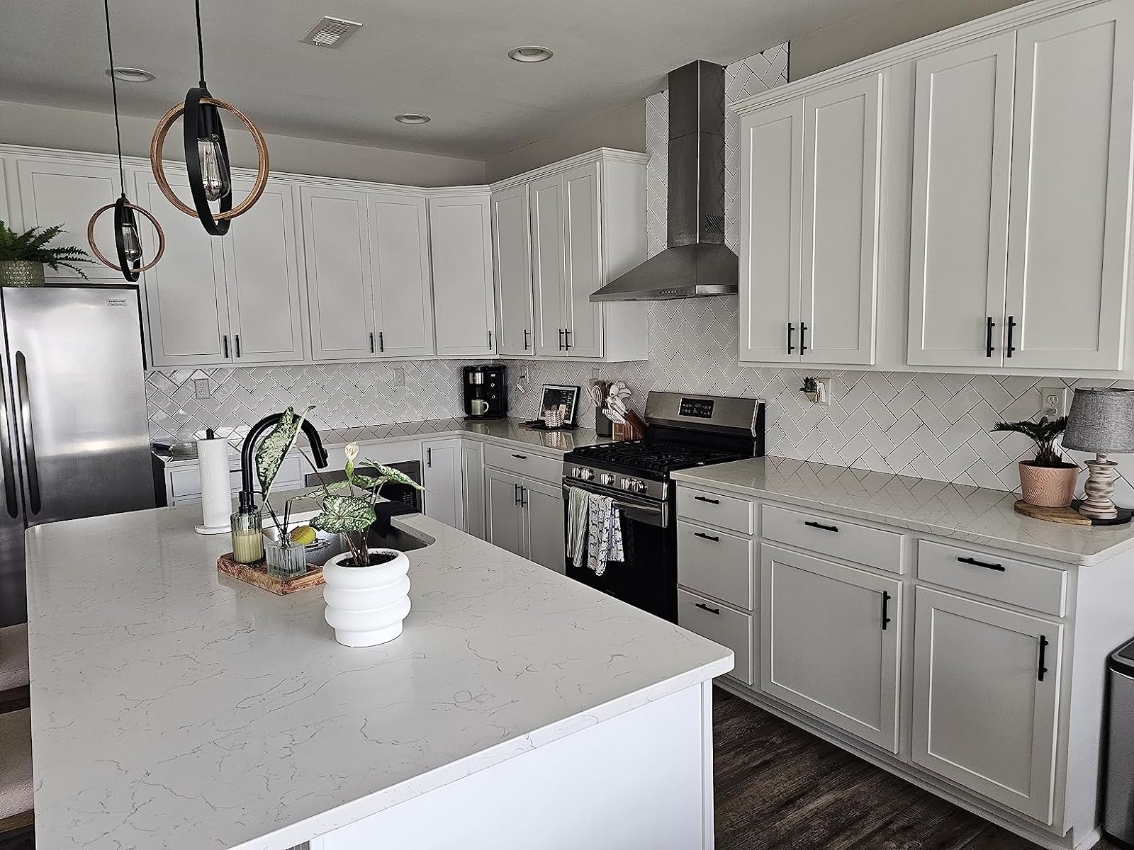 Reviewer image of white cabinets with black pulls