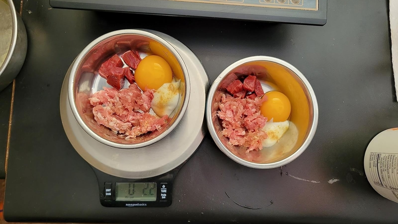 Reviewer image of meat and eggs portioned out in bowls and one on the scale