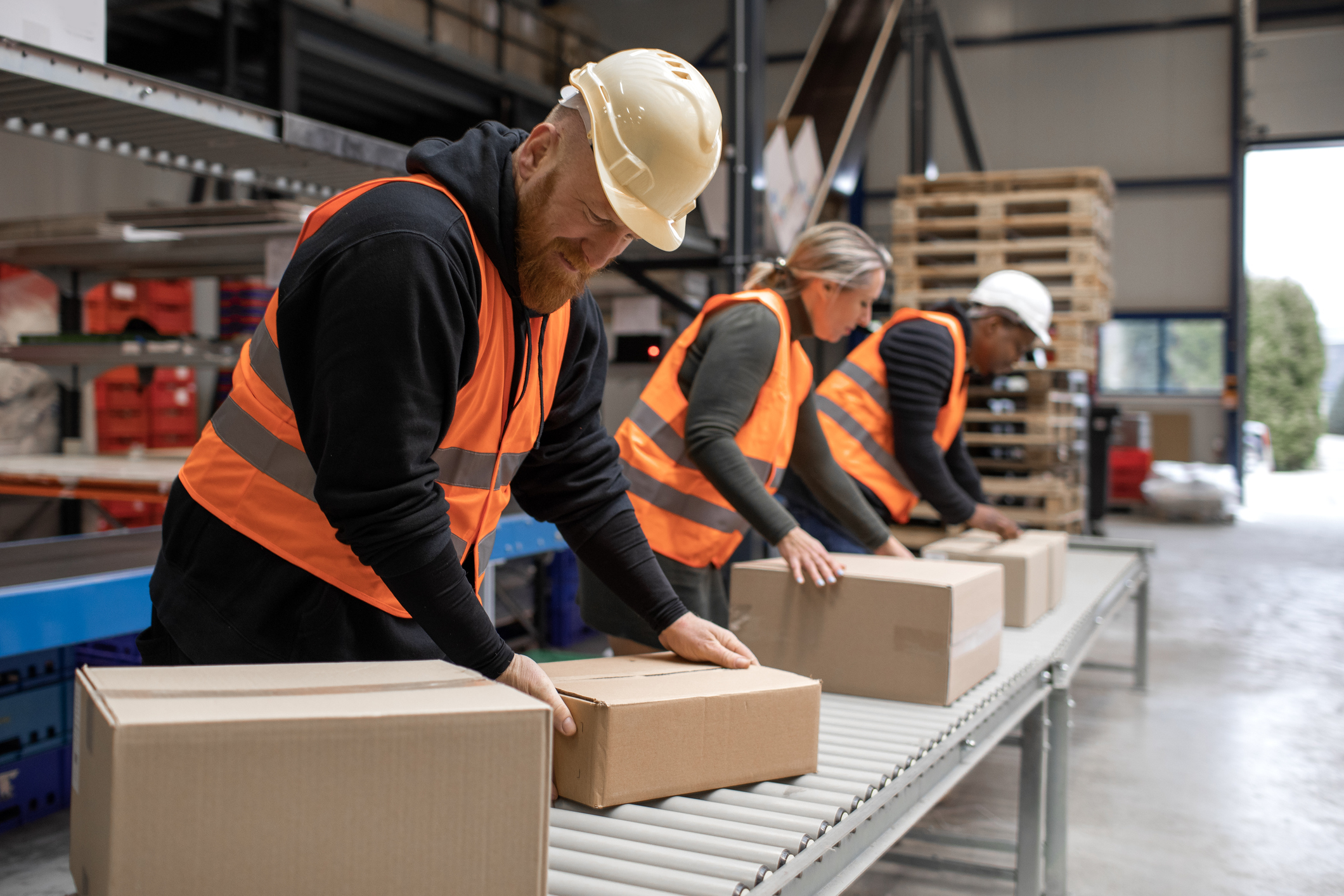 line of workers packaging boxes