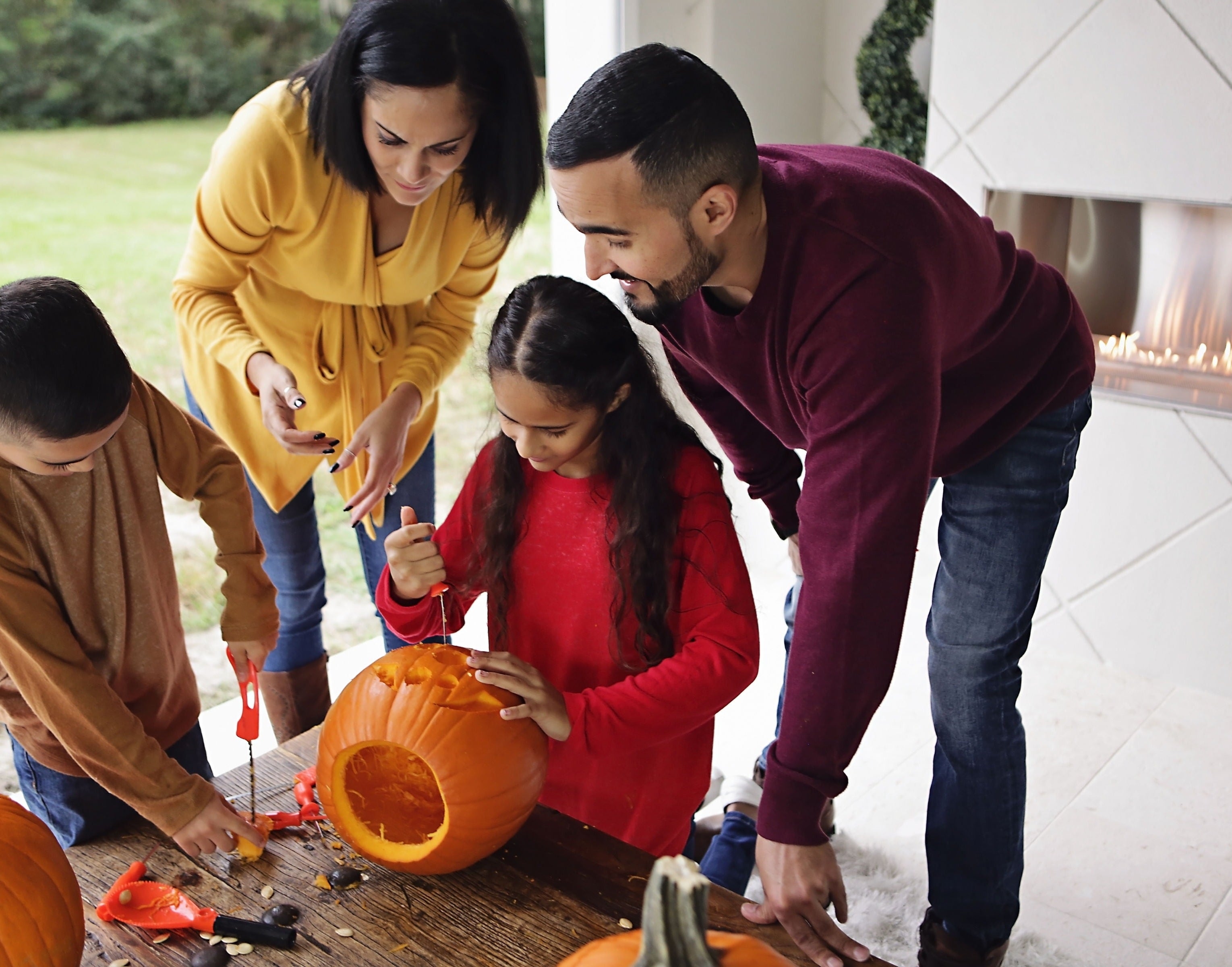 a family using the kit to carve a pumpkin