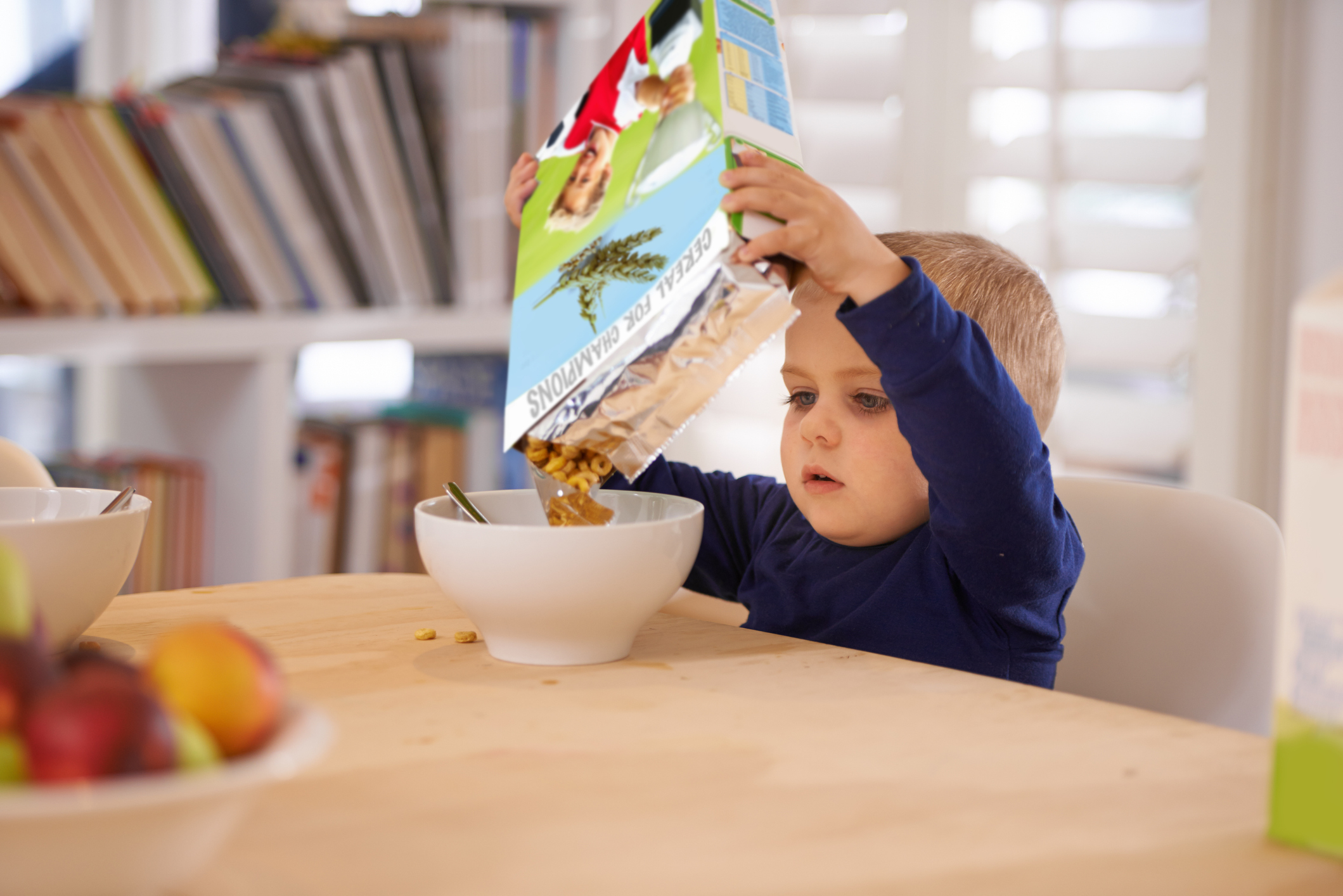 kid pouring cereal