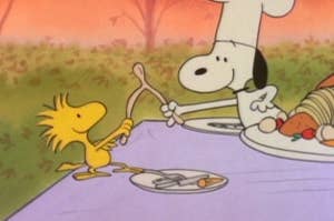 Woodstock and Snoopy with a wishbone.