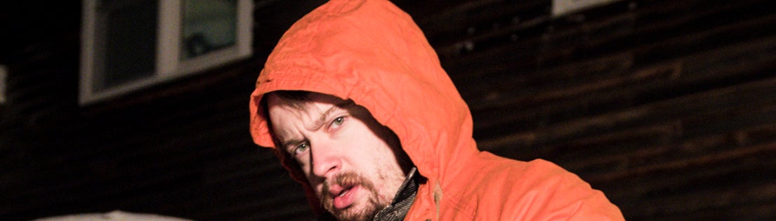 closeup of him in a hooded jacket