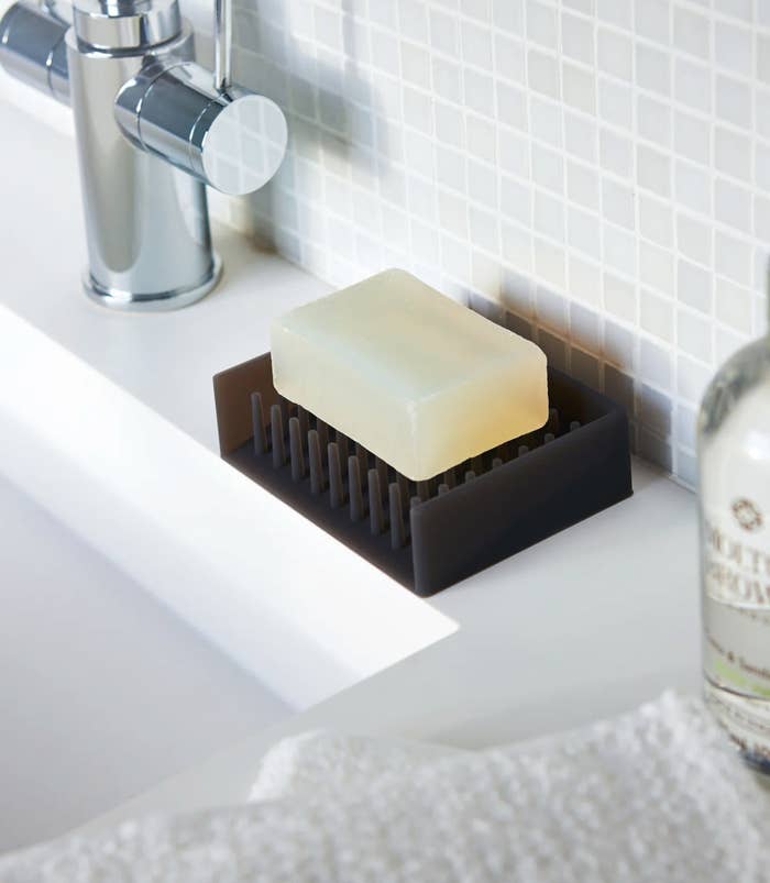 a bar of soap sitting on a plastic spiked soap dish