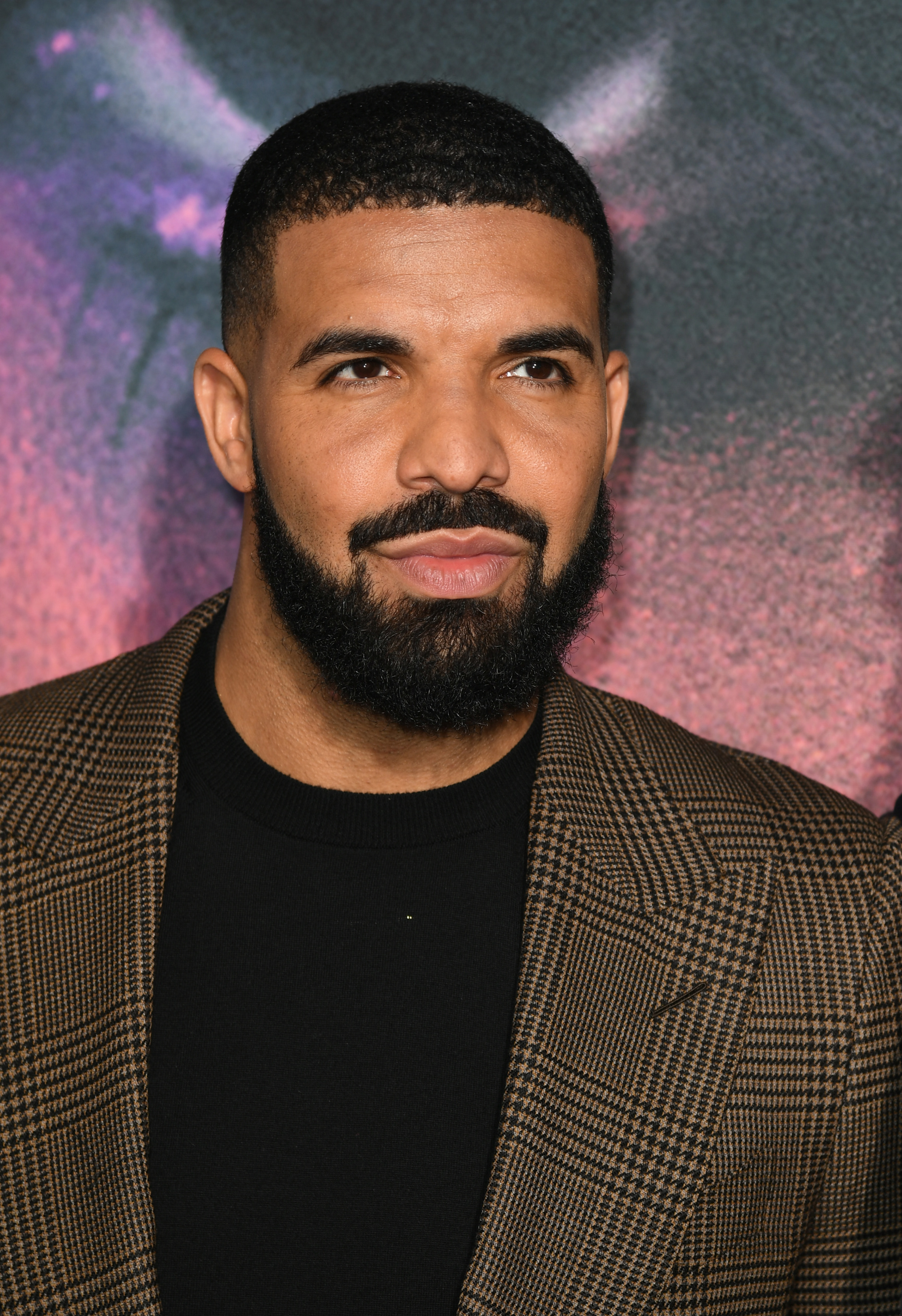 Close-up of Drake in a suit jacket