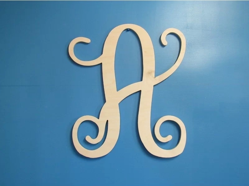 A natural wood letter A on a blue wall