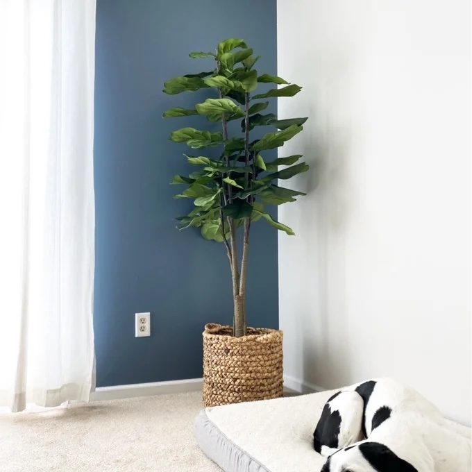a reviewer photo of the faux plant in a corner