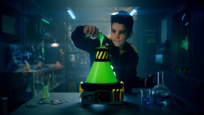Kid pours ingredients into toy chamber