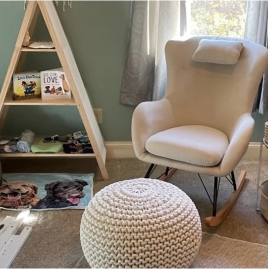 a reviewer photo of the beige rocking chair in a nursery