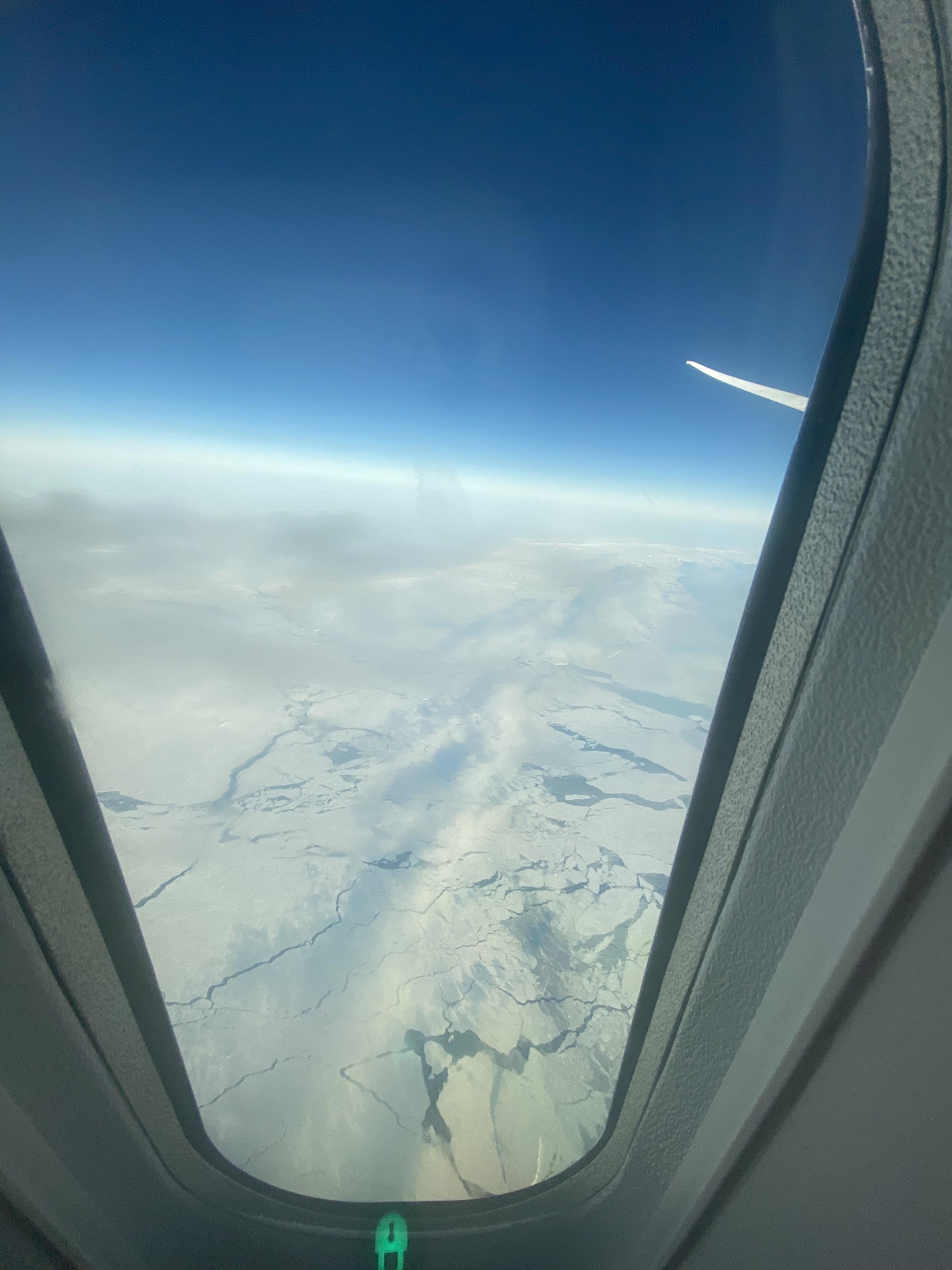 Flat-looking, nonverdant scene from an airplane window