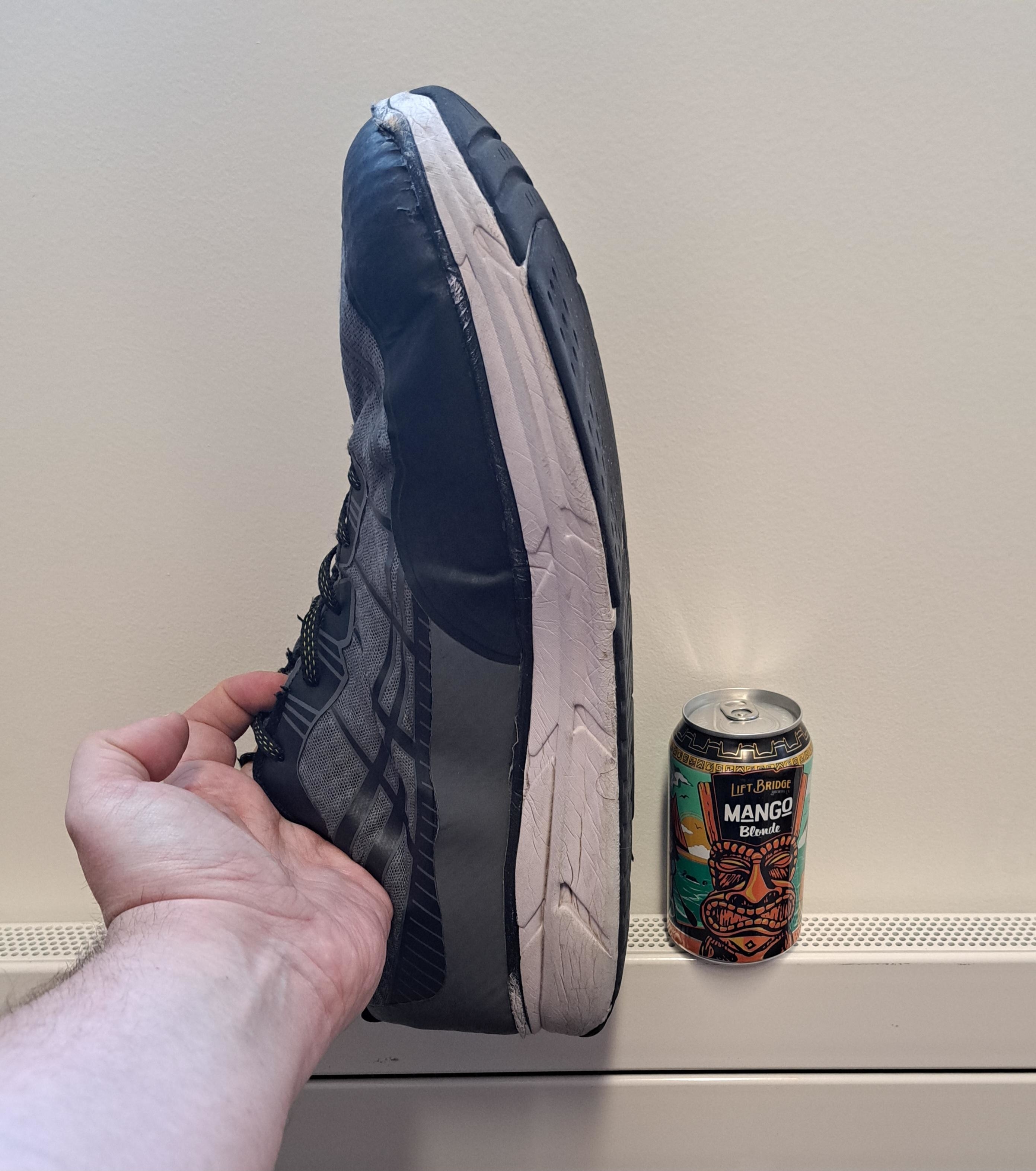 The sneaker is at least three or four times higher than the can