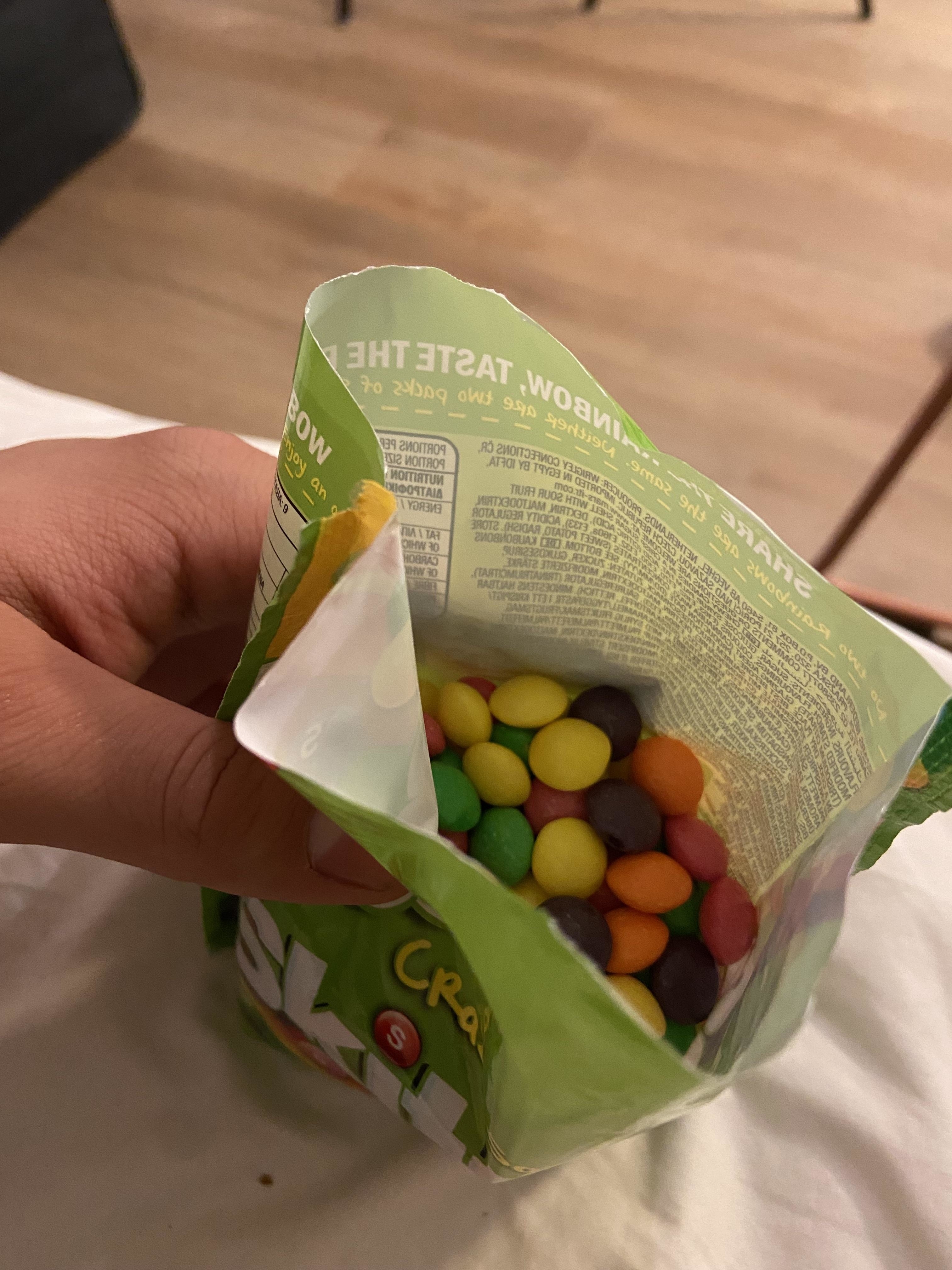 An open bag of Sour Skittles showing candy-coated Skittles looking like M&amp;amp;M&#x27;s