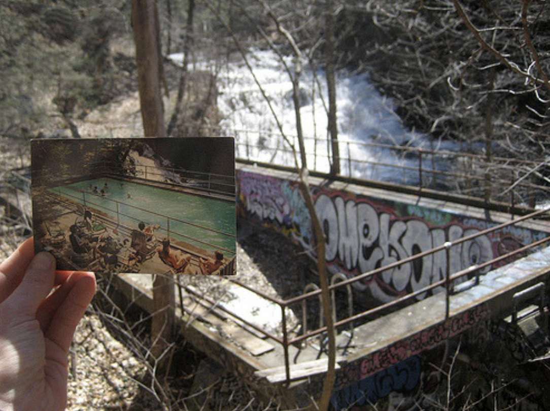 A person holding up a photo of a pool next to the abandoned pool