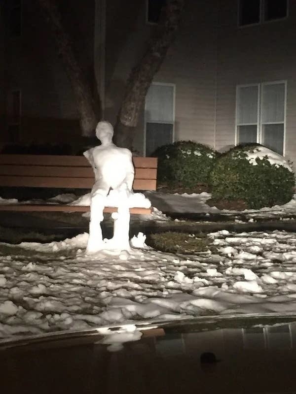 A snowman on a bench