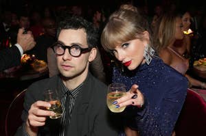 Jack Antonoff and Taylor Swift holding drinks