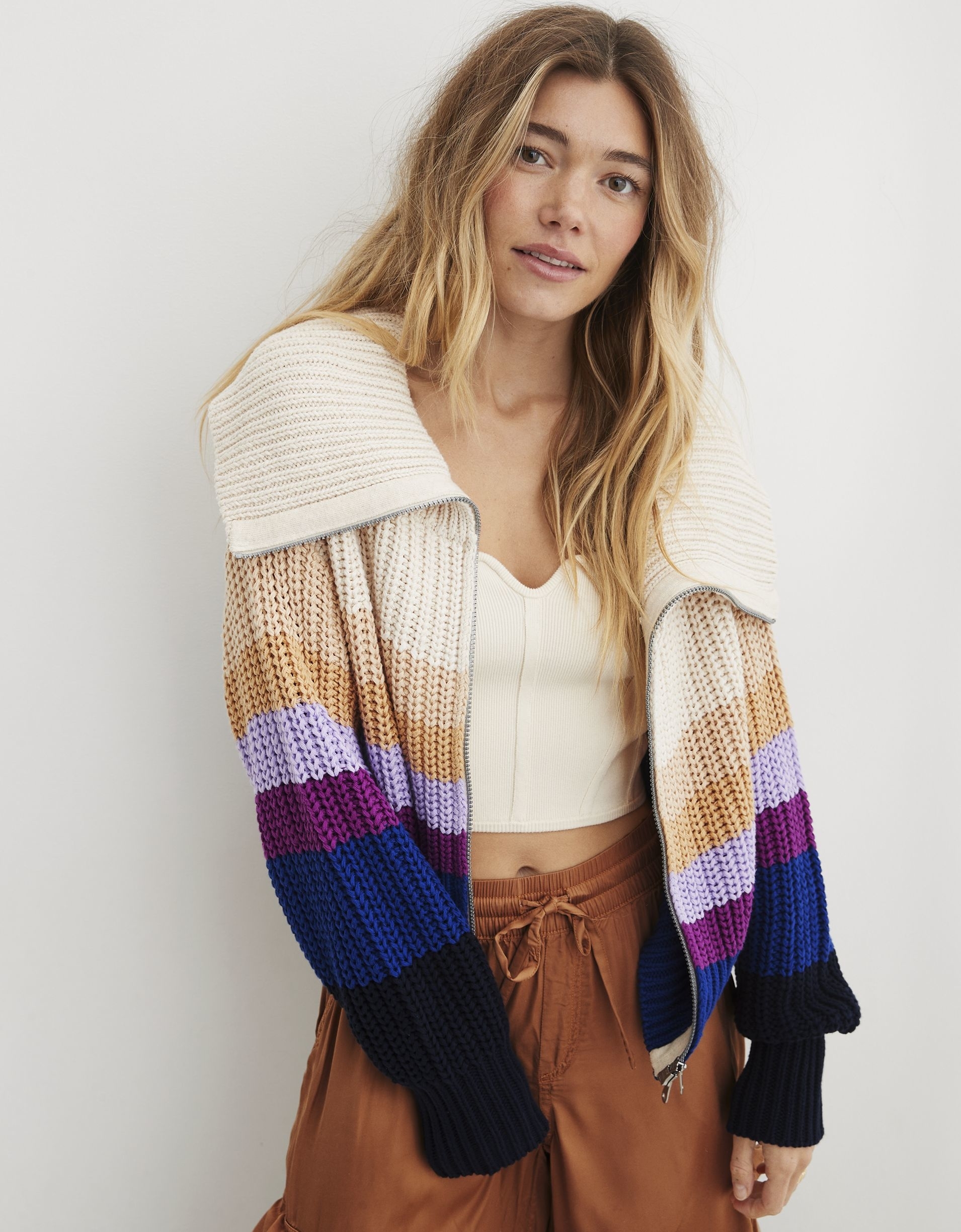 A model wearing the sweater with stripes