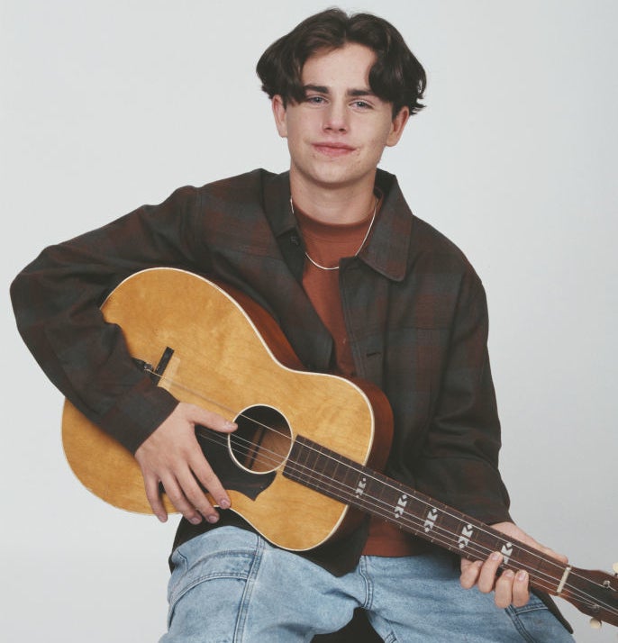 Rider Strong holding a guitar