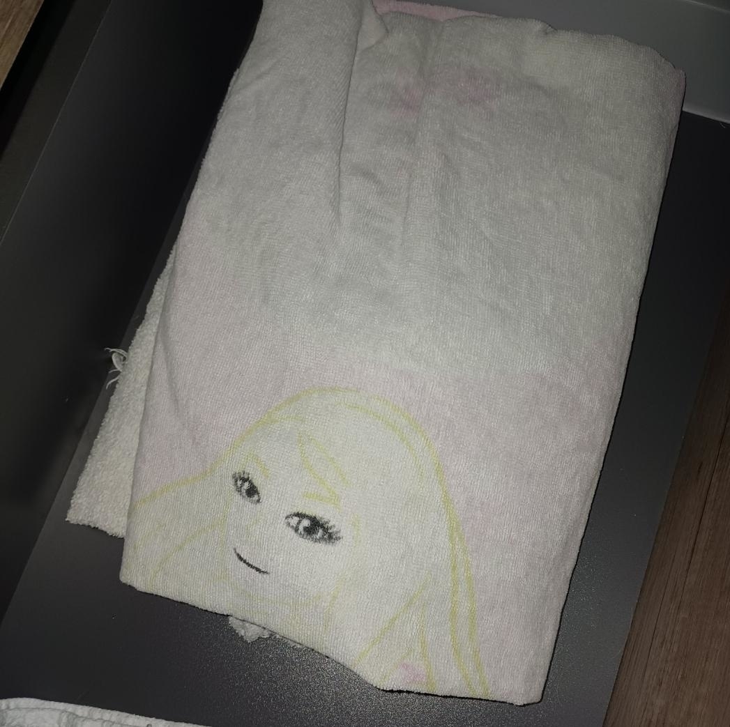 A faded towel with a face on it