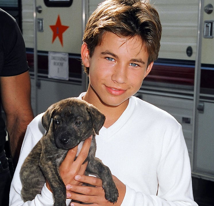 Jonathan Taylor Thomas holding a puppy