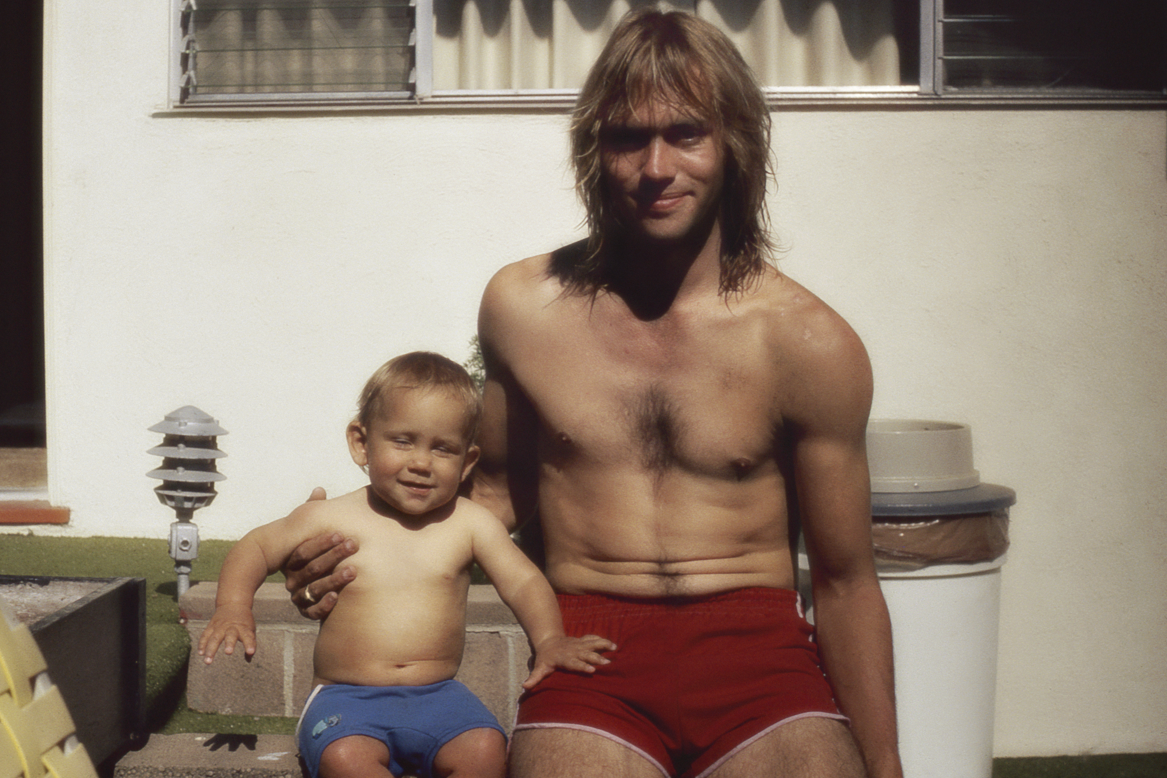 Vintage dad and son wearing swimming trunks
