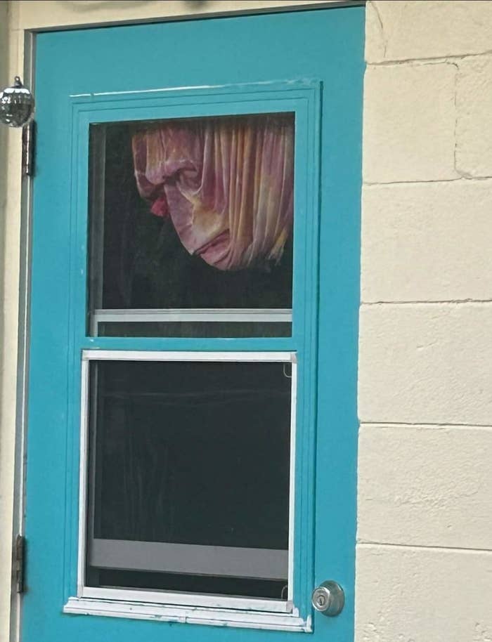 A curtain in a door that looks like a face