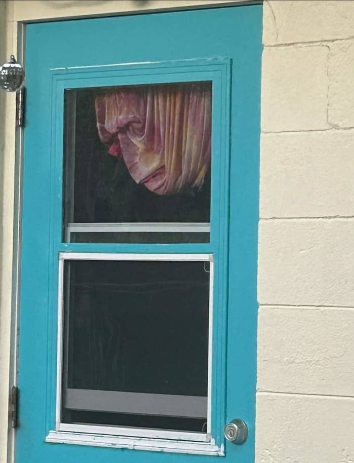 A curtain in a door that looks like a face