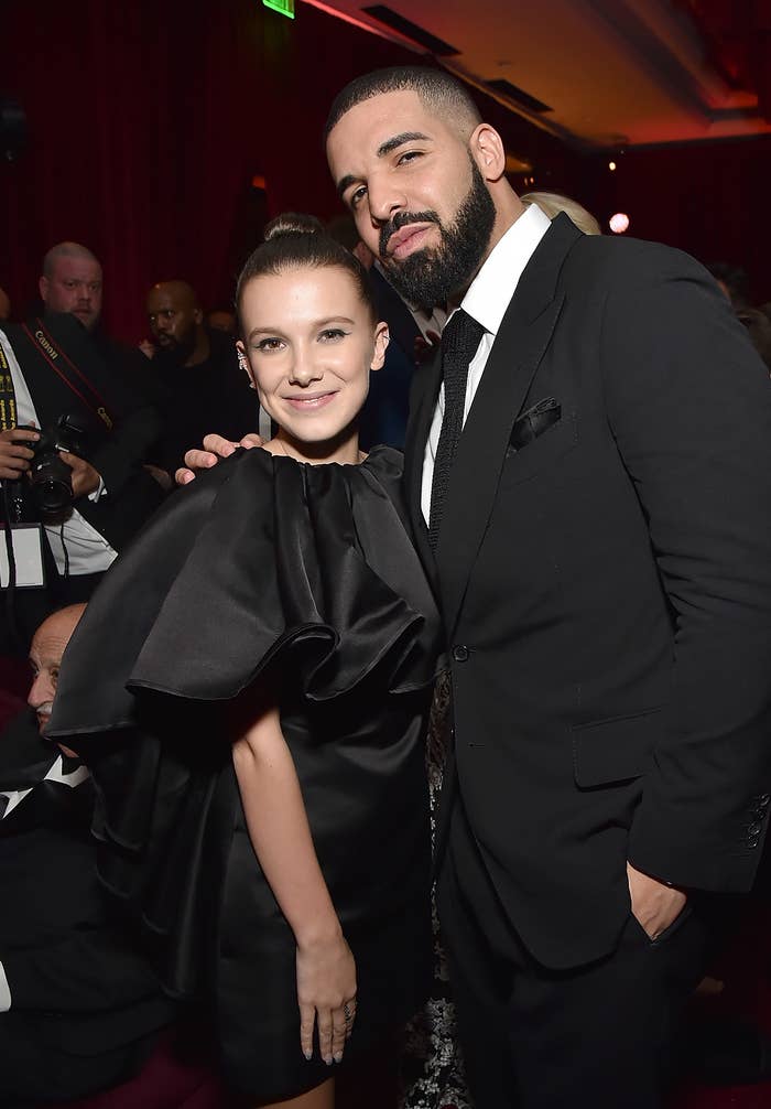 Millie Bobby Brown and Drake smile for a picture together at an event