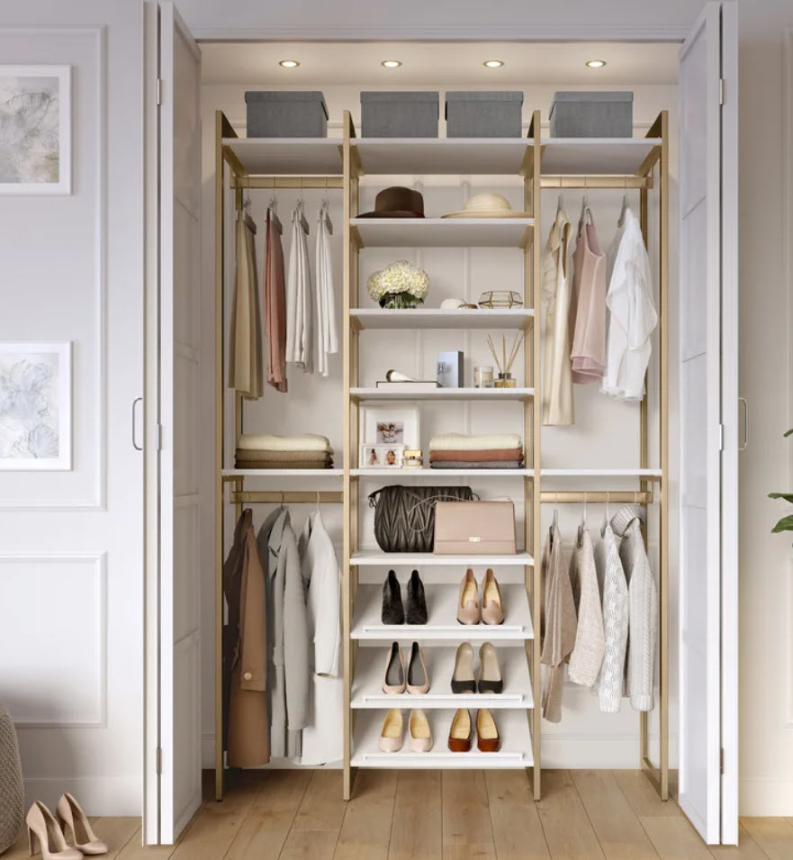 gold and white toned closet organizer with clothes and shoes stored