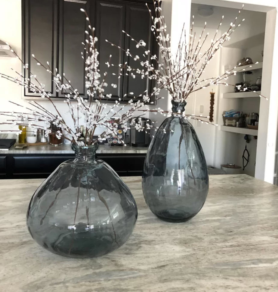 two clear glass wide and tall round vases with cherry blossoms