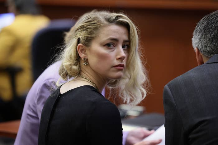 Closeup of Amber Heard in court looking over her shoulder