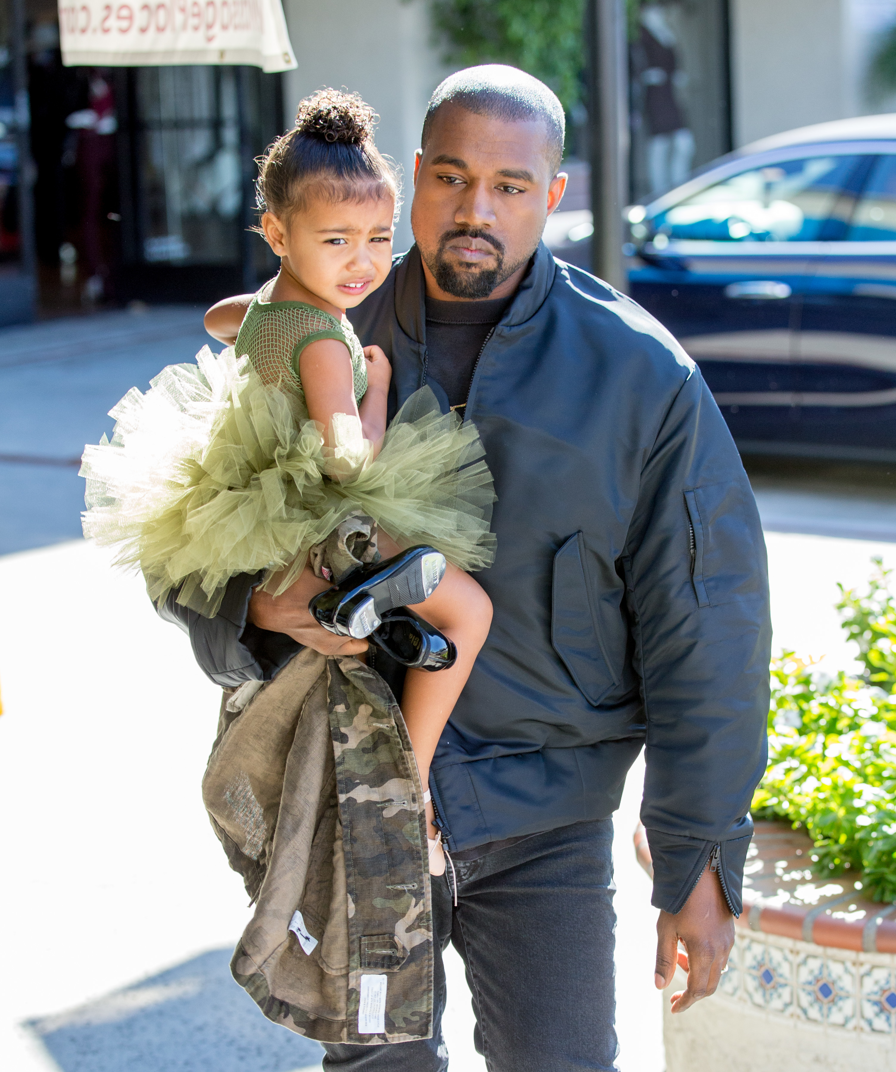 Kanye carrying a toddler North